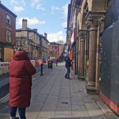 A participant of the photo walk looks down King Street