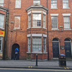 A red brick building on King Street with two large bay windows.