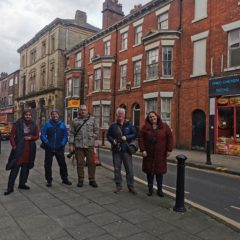 Participants of the photo walk stand in a line on King Street in Wigan.