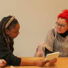Two workshop participants discuss their work